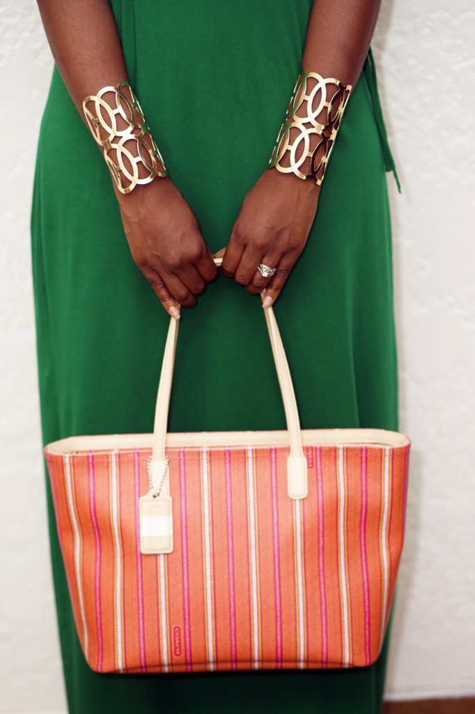 ALT = "coral striped coach bag gold cuff bracelets green dress"